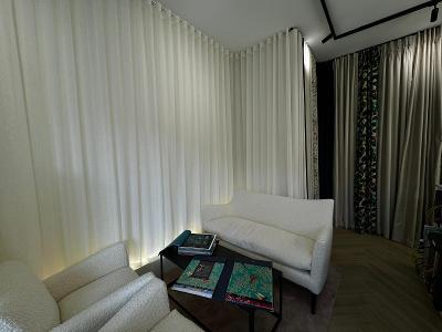 Seating area in Curtain showroom with sofas and coffee table and curtains on display