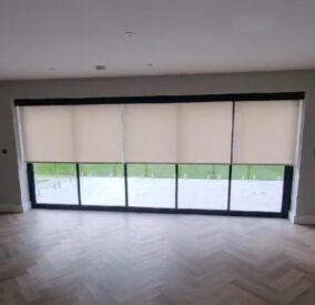 Electric Blinds fitted at Bifold Doors in North London. The blinds have been lowered to halfway.