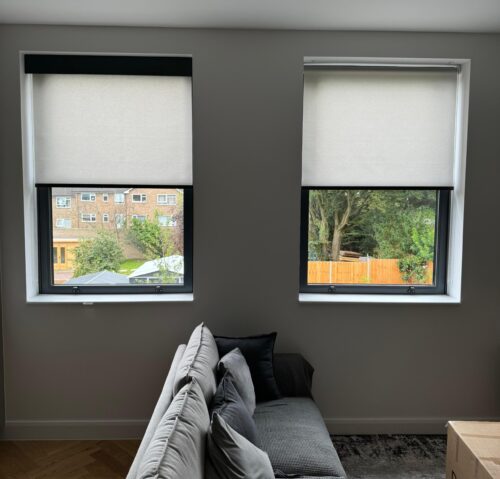 Two Electric Roller Blinds - on two windows side by side - one has Decorquip Capital Fascia 120mm fitted - one does not