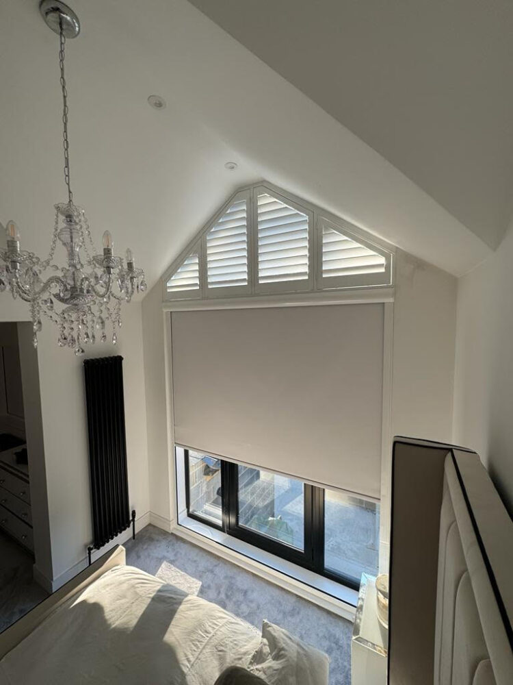 triangular white plantation shutters above a cassetted blackout roller blind in Central London