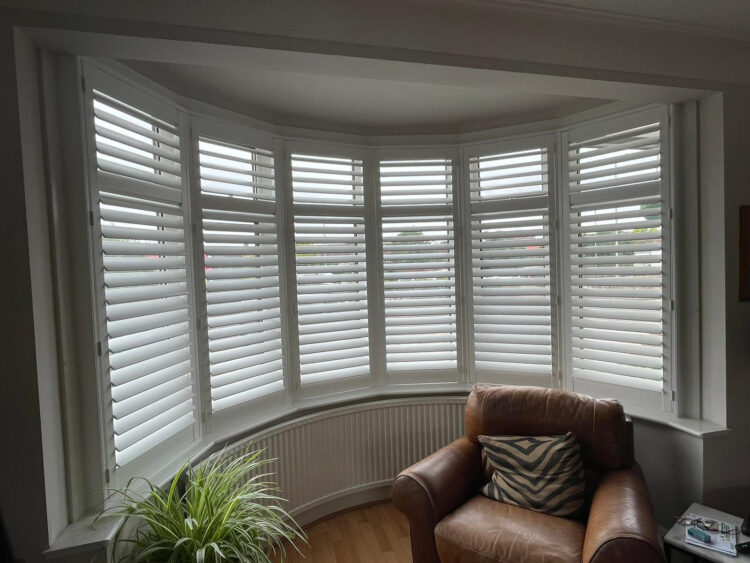 white painted wooden bay window plantation shutters in North London